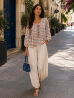 Peplum -style blouse with a tie-front detail.